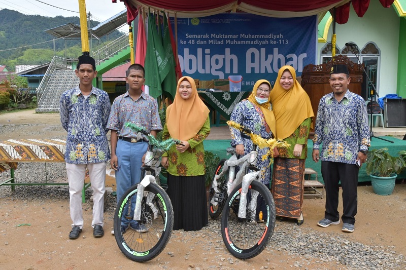 Kader terbaik Aisyiah Kabupaten Tapteng , Ny Citra Bakhtiar Ahmad Sibarani (dua dari kiri) saat menyerahkan bantuan hadiah dan uang tunai kepada 100 orang pada acara Tabligh Akbar dan Pawai Akbar Milad Muhammadiyah ke-113 dan Semarak Muktamar Muhammadiyah ke-48 SMK Muhammadiyah 11 Sibuluan, Sabtu (12/11/2022). (Batakpost.com/ist)